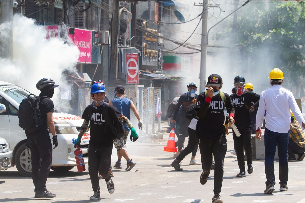 Tear gas and fire extinguisher gas float around demonstrators as they run away from police during a protest against the military coup in Yangon March 8, 2021. u00e2u20acu201d Reuters pic