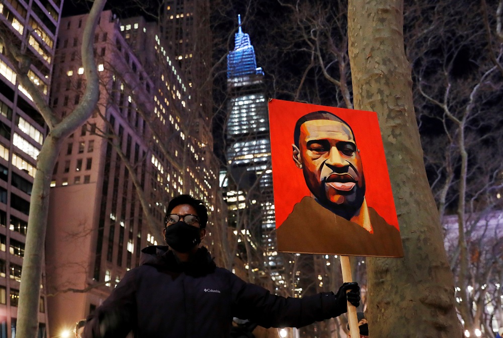 A demonstrator holds up an image of George Floyd during a rally on the first day of the trial of former Minneapolis police officer Derek Chauvin, on murder charges in the death of Floyd, in New York March 8, 2021. u00e2u20acu201d Reuters pic