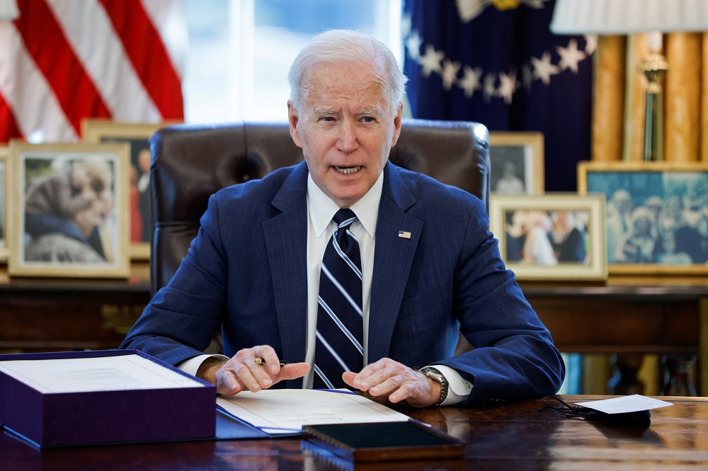 US President Joe Biden signs the American Rescue Plan, a package of economic relief measures to respond to the impact of the coronavirus disease pandemic, inside the Oval Office at the White House in Washington March 11, 2021. u00e2u20acu201d Reuters pic