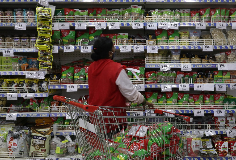 A worker arranges staple goods inside a Reliance supermarket in Mumbai March 16, 2021. u00e2u20acu201d Reuters pic