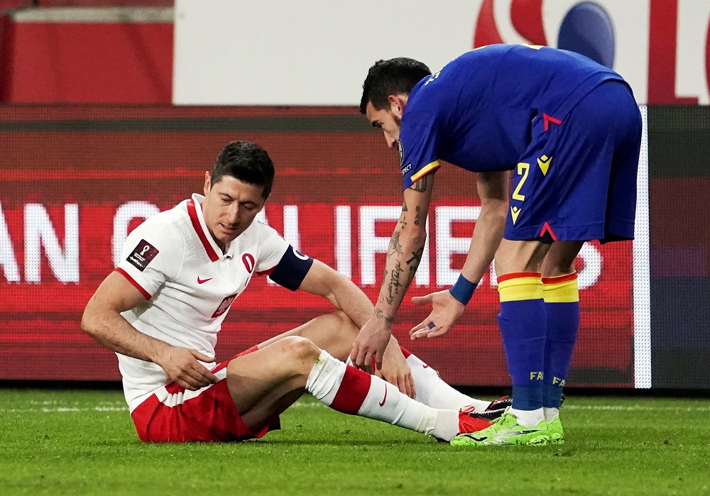 Polandu00e2u20acu2122s Robert Lewandowski reacts after sustaining an injury as Andorrau00e2u20acu2122s Cristian Martinez looks on, at the Polish Army Stadium in Warsaw March 28, 2021. u00e2u20acu201d Reuters pic