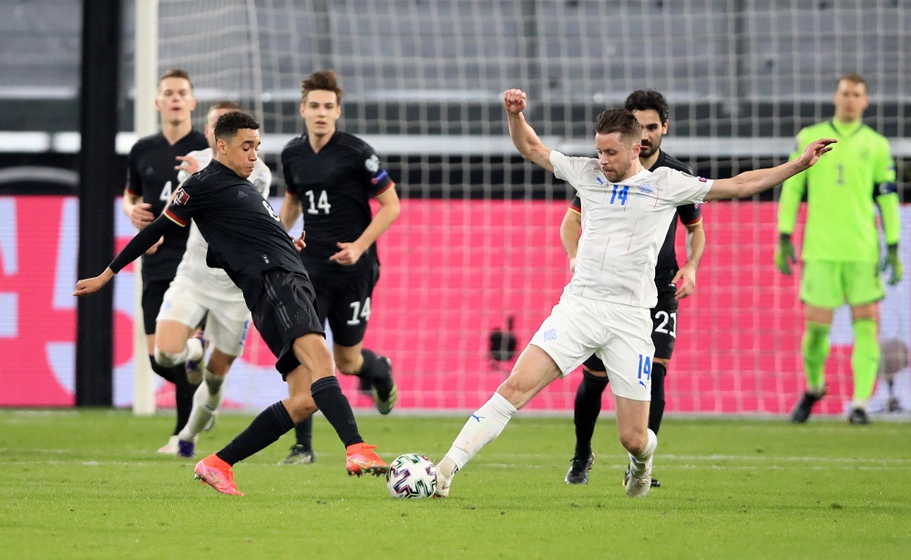 Germany's Jamal Musiala in action with Iceland's Kari Arnason March 26, 2021. u00e2u20acu2022 Reuters pic