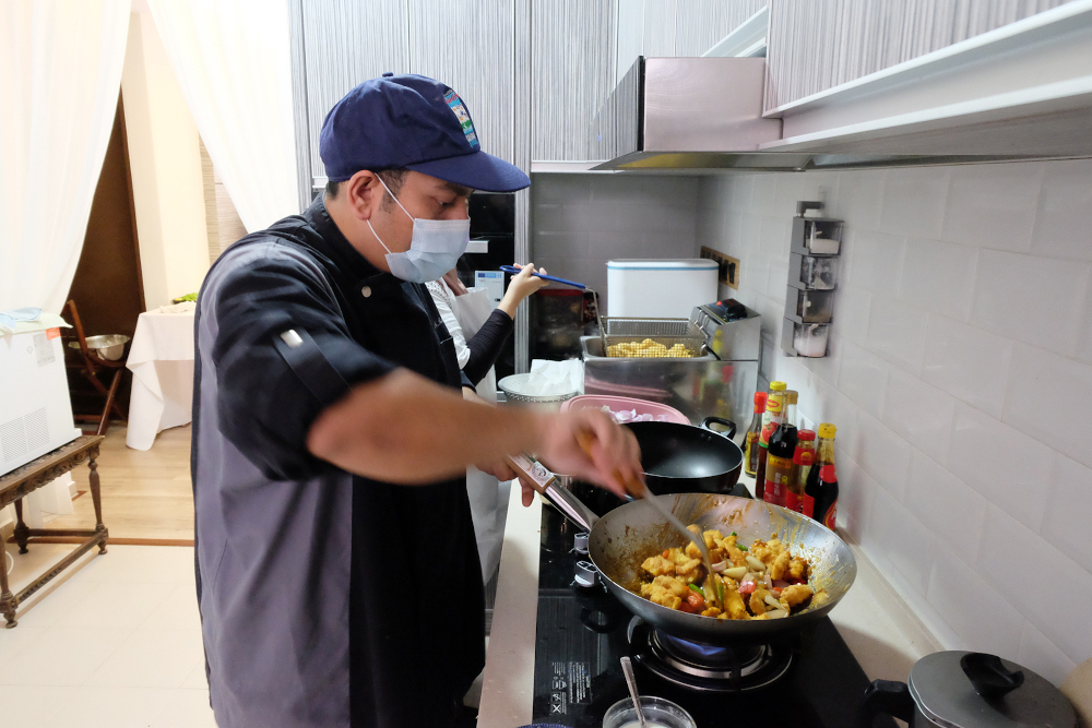 Nisha Rezqi cooking up the meal of the day at the kitchen. — Picture by Steven Ooi KE