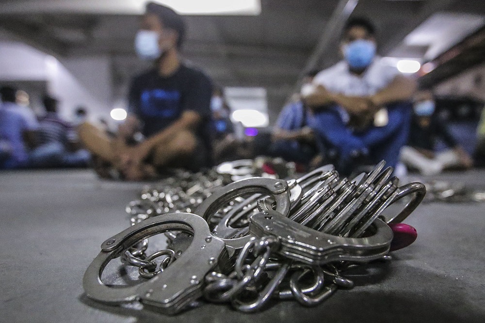 Officers and personnel from the Kuala Lumpur Immigration Department nab 205 foreigners during a raid at Ixora Apartment in Pudu, Kuala Lumpur March 6, 2021. u00e2u20acu201d Picture by Hari Anggara