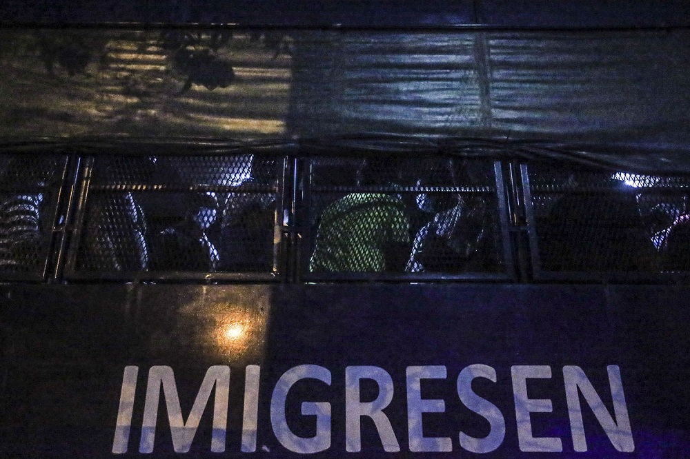 Foreigners nabbed during a raid are seen in an Immigration Department vehicle, in Kuala Lumpur March 6, 2021. u00e2u20acu201d Picture by Hari Anggara