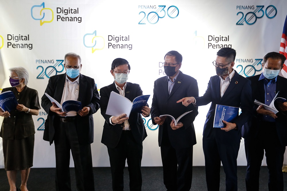 Penang Chief Minister Chow Kon Yeow (centre) with a copy of the Digital Transformation Master Plan booklet during a group photo following the launch of Digital Penang at Wisma Yeap Chor Ee in George Town March 12, 2021. u00e2u20acu201d Picture by Sayuti Zainudin