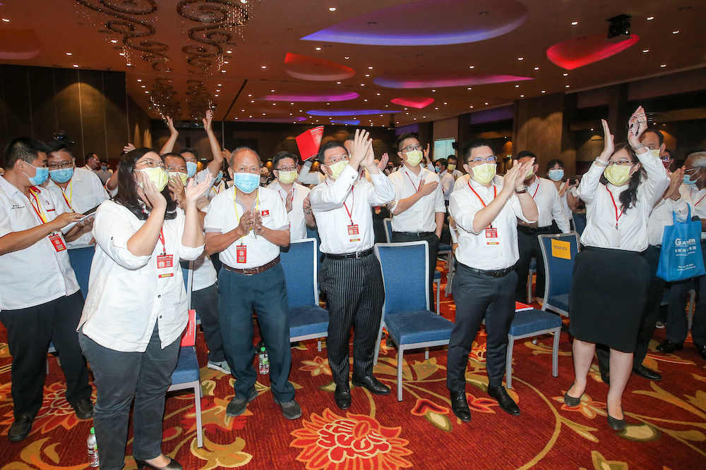 DAP reps cheer after Perak DAP chairman Nga Kor Ming and advisor Datuk Ngeh Koo Ham today retained their posts at the state DAP party election at the Ipoh Convention Centre March 14, 2021.