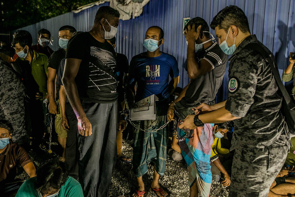 Immigration Department officers detain foreign workers during a raid at a construction site in Kuala Lumpur on March 20, 2021. u00e2u20acu201d Picture by Firdaus Latifnn