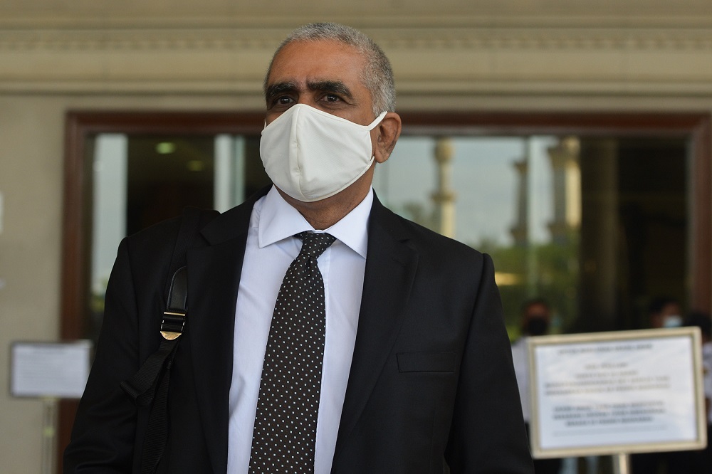 Lawyer M. Puravalen, who is representing the accused in a molest case, arrives at the Kuala Lumpur High Court March 22, 2021. u00e2u20acu201d Picture by Miera Zulyana