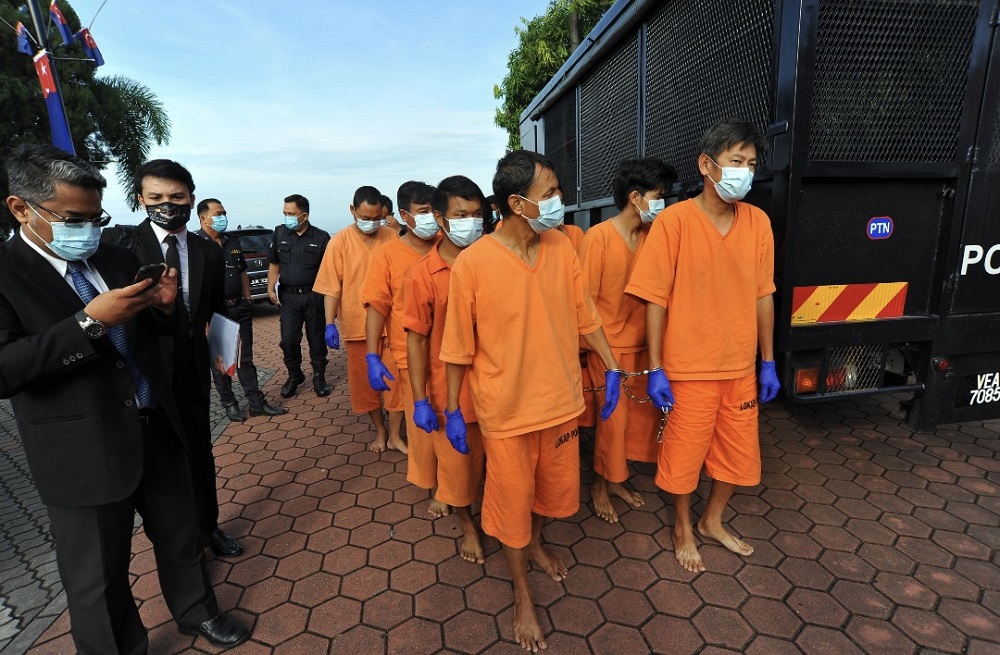 The accused, consisting of Myanmar nationals and a sole Singaporean, arrive at the Pontian Magistrateu00e2u20acu2122s Court March 22, 2021.  u00e2u20acu201d  Picture by Ben Tan