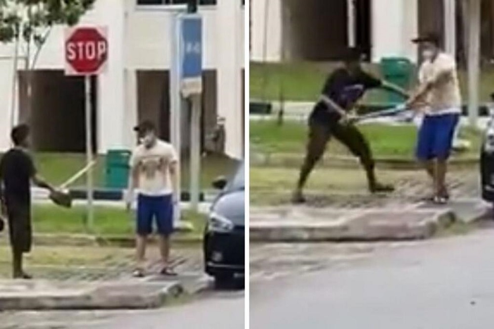 Neo Hong Wei, armed with a kitchen knife (right in photos), is confronted by an off-duty police officer who was carrying a hoe that he had borrowed from a nearby construction site. u00e2u20acu201d Picture via Roads.sg/Facebook