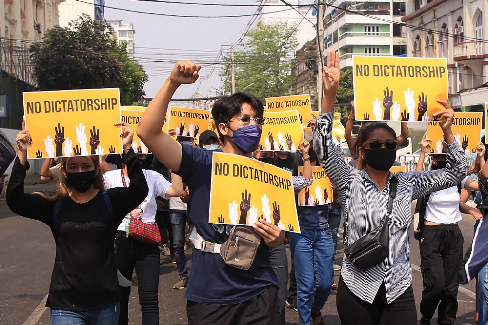 This photo taken and received from an anonymous source via Facebook on March 26, 2021 shows protesters carrying signs during a demonstration against the military coup in Yangon. u00e2u20acu201d Facebook handout via AFP 