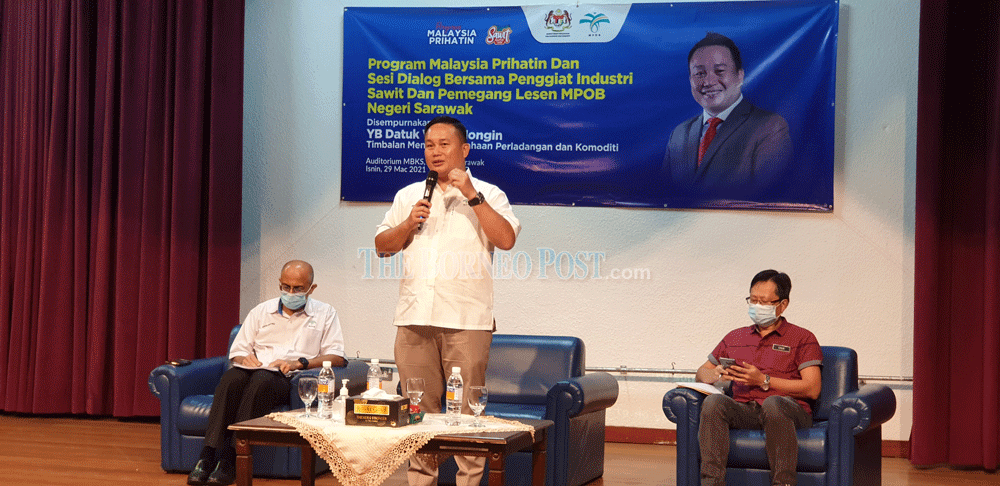 Deputy Minister II of Plantation Industries and Commodities Datuk Willie Mongin (centre) delivers his presentation during the dialogue held at MBKS Auditorium. u00e2u20acu201d Borneo Post Online pic