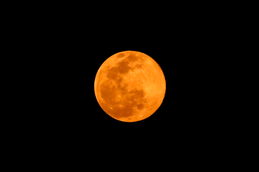 A full moon above the Kathmandu valley looks orange due to air pollution in Kathmandu, Nepal March 28, 2021. u00e2u20acu201d Reuters pic