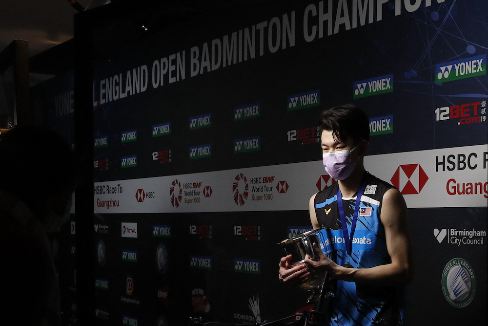 Lee Zii Jia is interviewed remotely holding the winner's trophy after beating Denmark's Viktor Axelsen during the men's singles final of the All England Open Badminton Championship at the Utilita Arena, March 21, 2021. u00e2u20acu201d AFP pic
