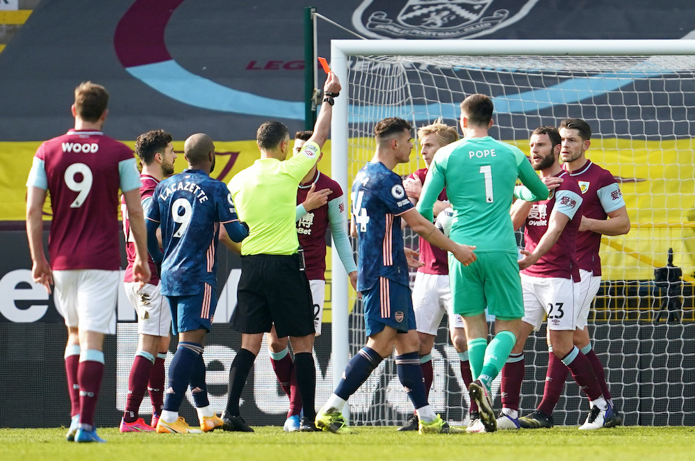 Burnleyu00e2u20acu2122s Erik Pieters is shown a red card by referee Andre Marriner which is later overturned after a VAR review during the match against Arsenal at the Turf Moor Stadium in Burnley, March 6, 2021. u00e2u20acu201d Reuters picnn