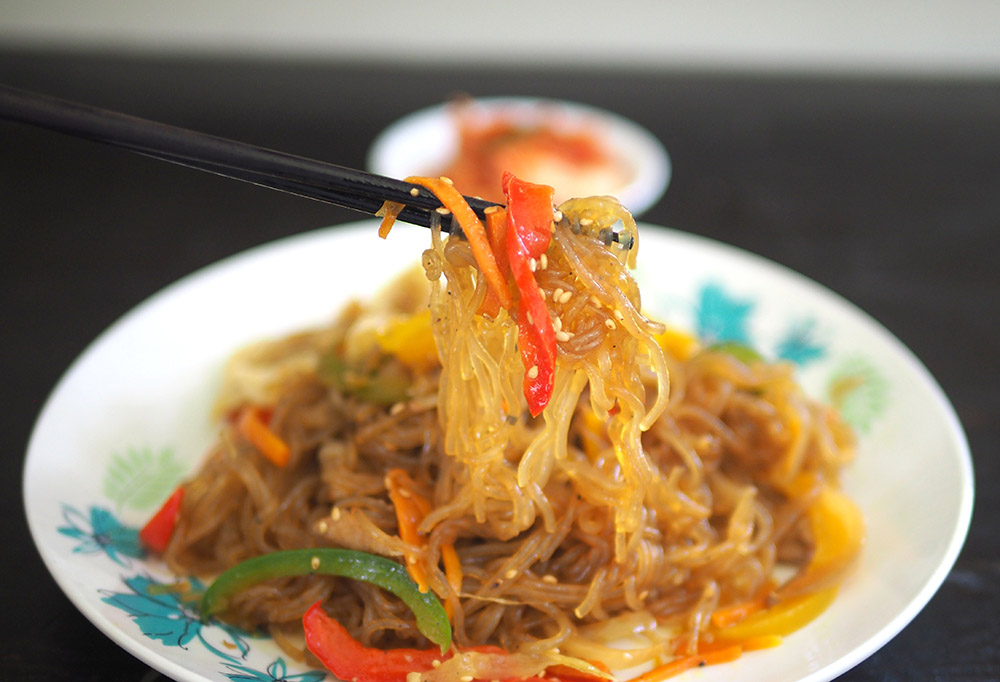 The potato glass noodles are slick with the delicious sauce and paired with vegetables and toasted sesame seeds.