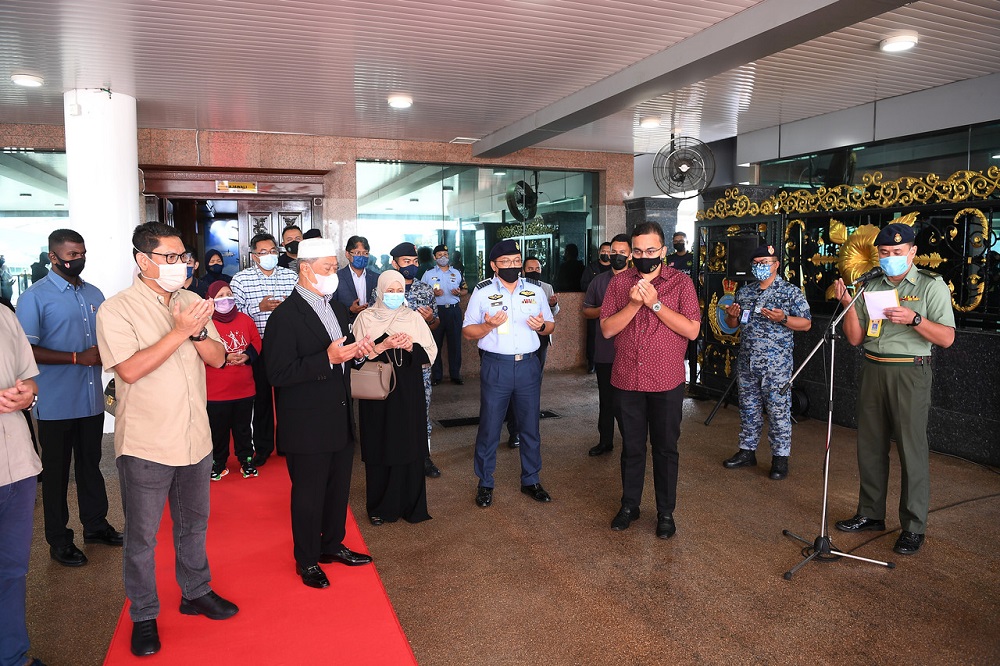 Prime Minister Tan Sri Muhyiddin Yassin and his wife Puan Sri Noorainee Abdul Rahman pray before leaving for Mecca, at the RMAF Subang Air Base March 6, 2021. u00e2u20acu201d Bernama pic