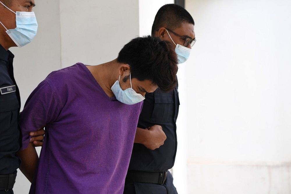 Mohamad Asyraf Haniff Ramlee, 25, is led out of the Magistrateu00e2u20acu2122s Court in Maran March 15, 2021. u00e2u20acu201d Bernama pic