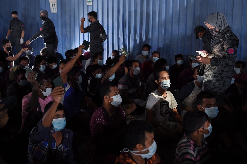 Immigration Department officers perform a document check on foreigners during a raid at Jalan Imbi in Kuala Lumpur March 20, 2021. u00e2u20acu201d Bernama pic