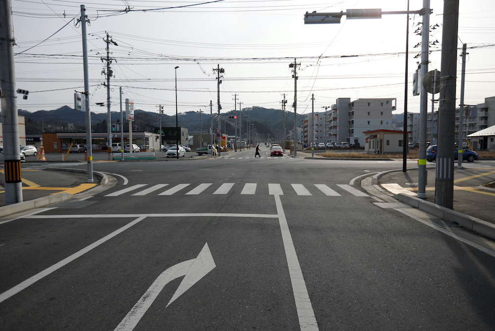 A passerby and cars are seen at the area which was devastated by the March 11, 2011 earthquake and tsunami in Kesennuma, Miyagi Prefecture, northern Japan March 1, 2021. u00e2u20acu201d Reuters picnn