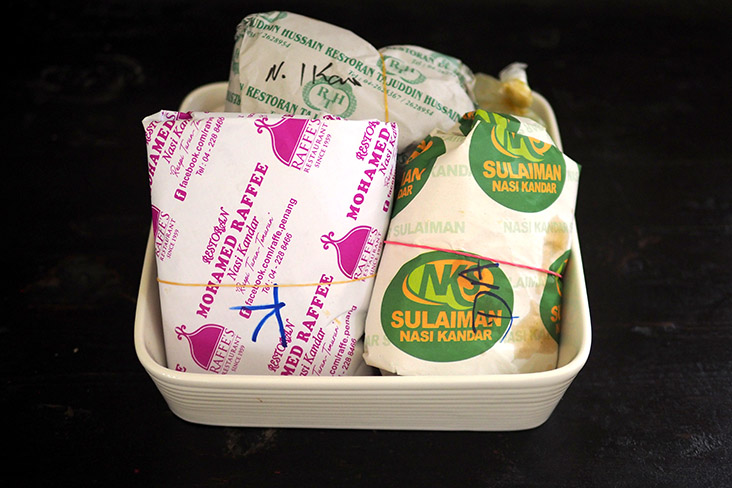 Your 'nasi kandar' will be packed in plastic wrap and paper.