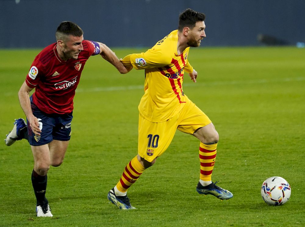 Osasunau00e2u20acu2122s Oier in action with Barcelonau00e2u20acu2122s Lionel Messi during the La Liga match at El Sadar Stadium, Pamplona, Spain, March 6, 2021. u00e2u20acu201d Reuters pic