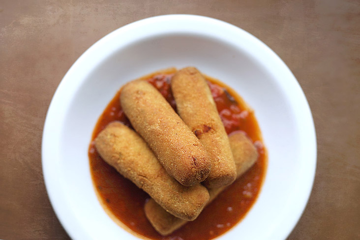 'Queso frito' made with Argentinian 'provoleta' cheese, served atop marinara sauce.