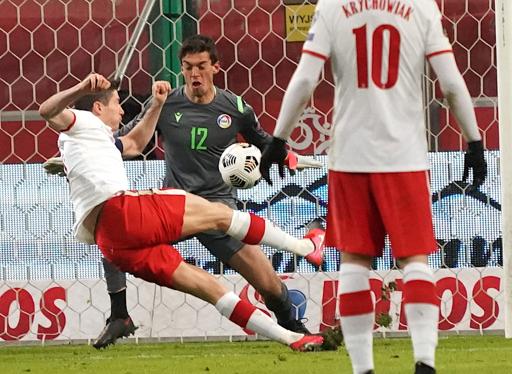 Polandu00e2u20acu2122s forward Robert Lewandowski scores past Andorrau00e2u20acu2122s goalkeeper Iker during the Fifa World Cup Qatar 2022 qualification football match Poland vs Andorra in Warsaw, March 28, 2021. u00e2u20acu201d AFP picnn