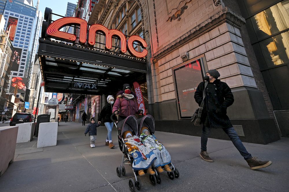 People walk past the AMC 42nd Street theater as movie theatres reopen at 25 per cent capacity across the city, New York, NY, March 5, 2021. u00e2u20acu201d Reuters pic