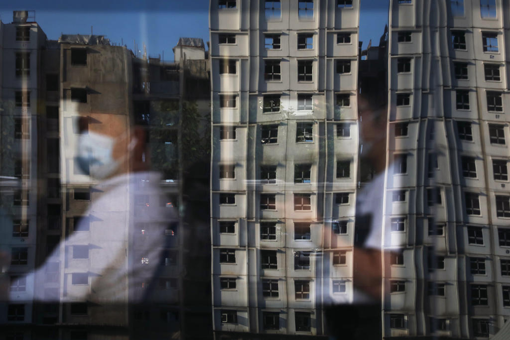 A reflection of new HDB flats under construction in Yishun, on Mar 10, 2021. For single Singaporeans, the road to securing a roof over their heads has been more challenging than some others. u00e2u20acu201d Photo by Ooi Boon Keong for TODAYnn