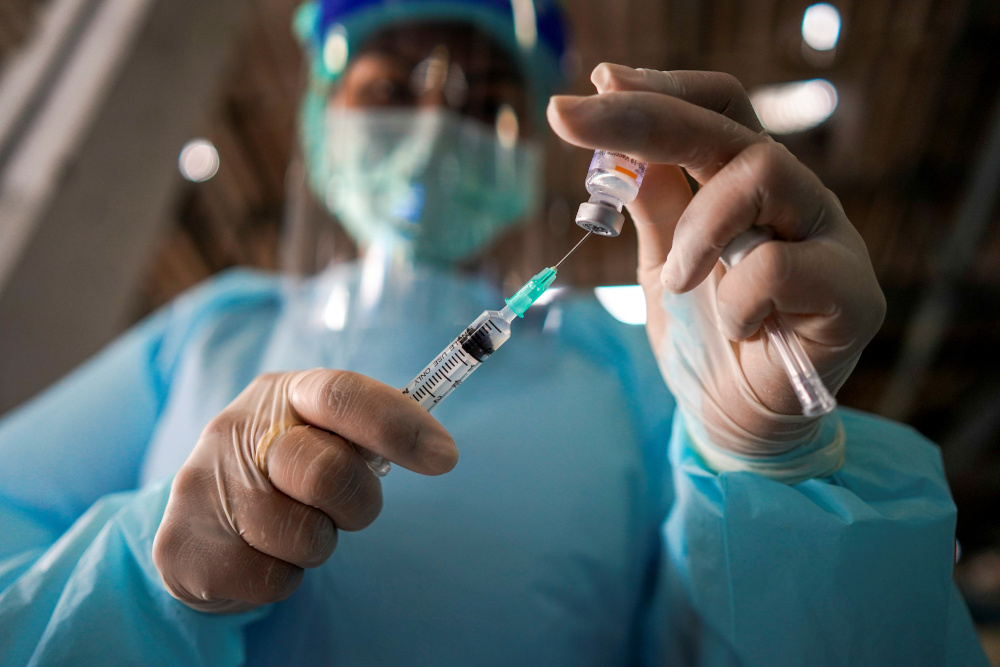 A health worker prepares to administer the Sinovac coronavirus disease vaccine at a market after hundreds of local residents in the district tested positive for Covid-19 in Bangkok, Thailand, March 17, 2021. u00e2u20acu201d Reuters pic 
