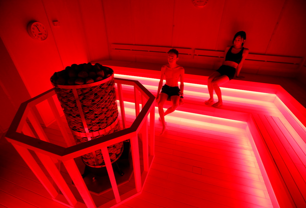 Staffs of teamLab wearing swimming suits use a sauna during a demonstration of TikTok teamLab Reconnect, digital artwork combined with sauna, ahead of its opening to the public this month in Tokyo, Japan, March 13, 2021. — Reuters pic