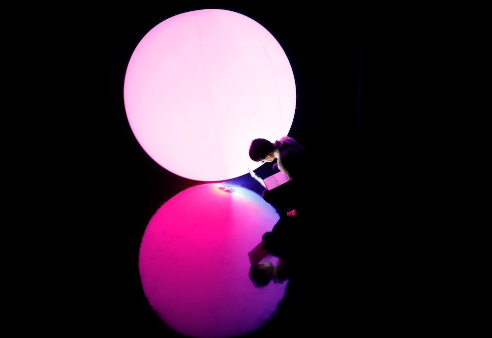 A staff of teamLab checks a digital artwork titled as Levitation during a demonstration of TikTok teamLab Reconnect, digital artwork combined with sauna, ahead of its opening to the public this month in Tokyo, Japan, March 13, 2021. — Reuters pic