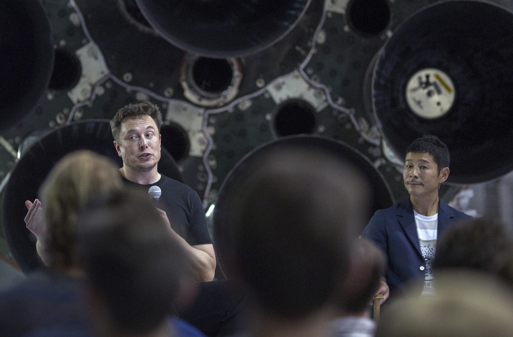 This file photo taken September 17, 2018 shows SpaceX founder Elon Musk and Japanese billionaire Yusaku Maezawa speaking before a Falcon 9 rocket at the SpaceX headquarters and rocket factory in Hawthorne, California. u00e2u20acu201d AFP picnn