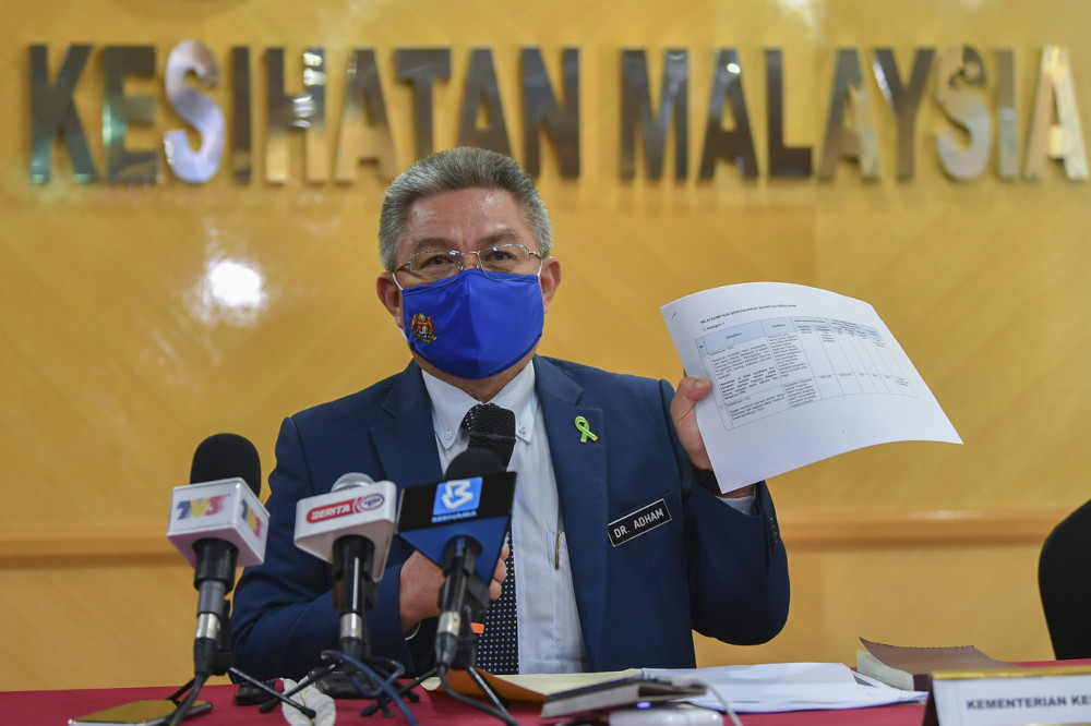 Health Minister Datuk Seri Dr Adham Baba shows the list of fines based on the offences committed in Putrajaya, March 31, 2021. u00e2u20acu201d Bernama picn
