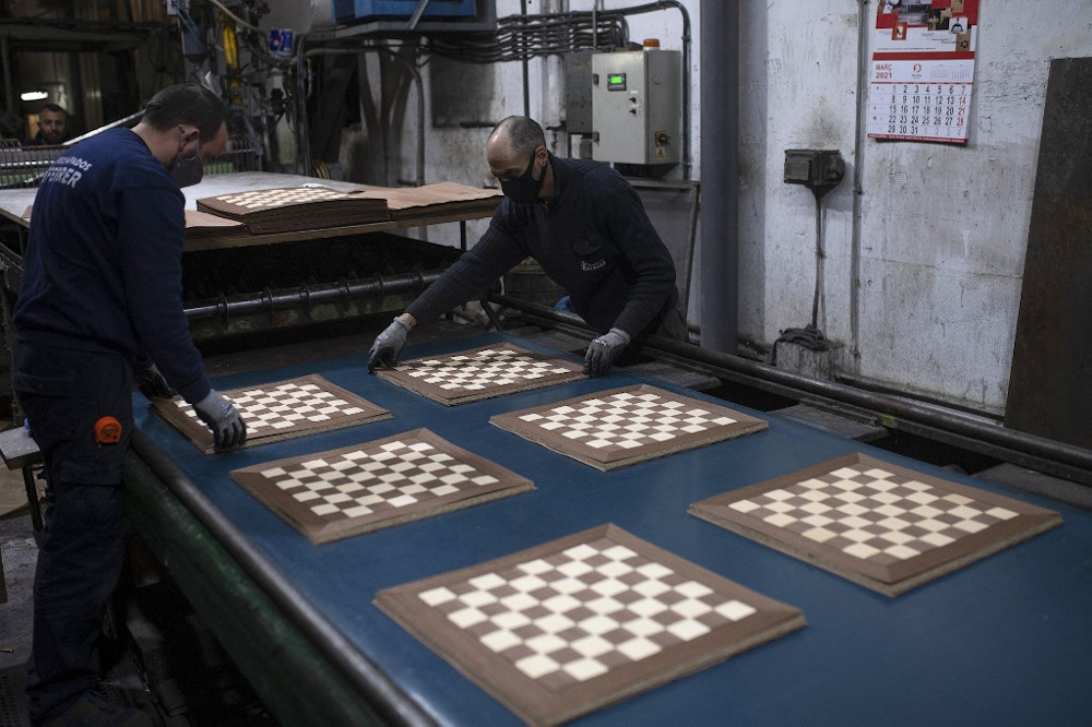 Employees of Rechapados Ferrer make chessboards in La Garriga March 5, 2021. The Spanish chessboard makeru00e2u20acu2122s sales have soared since being featured on the hit Netflix series u00e2u20acu02dcThe Queenu00e2u20acu2122s Gambitu00e2u20acu2122. u00e2u20acu201d AFP pic