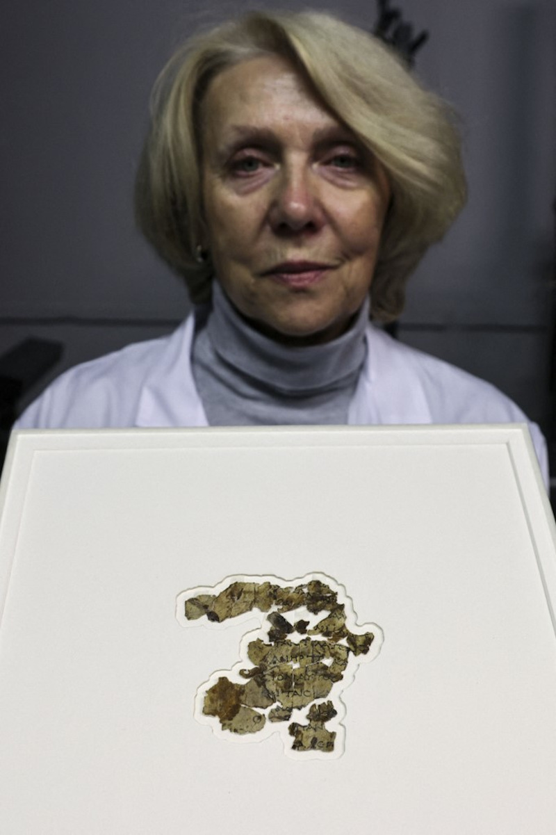 Israel Antiquities Authority (IAA) conservator Tanya Bitler displays recently-discovered 2000-year-old biblical scroll fragments from the Bar Kochba period, after completion of preservation work in Jerusalem, on March 16, 2021. — AFP pic