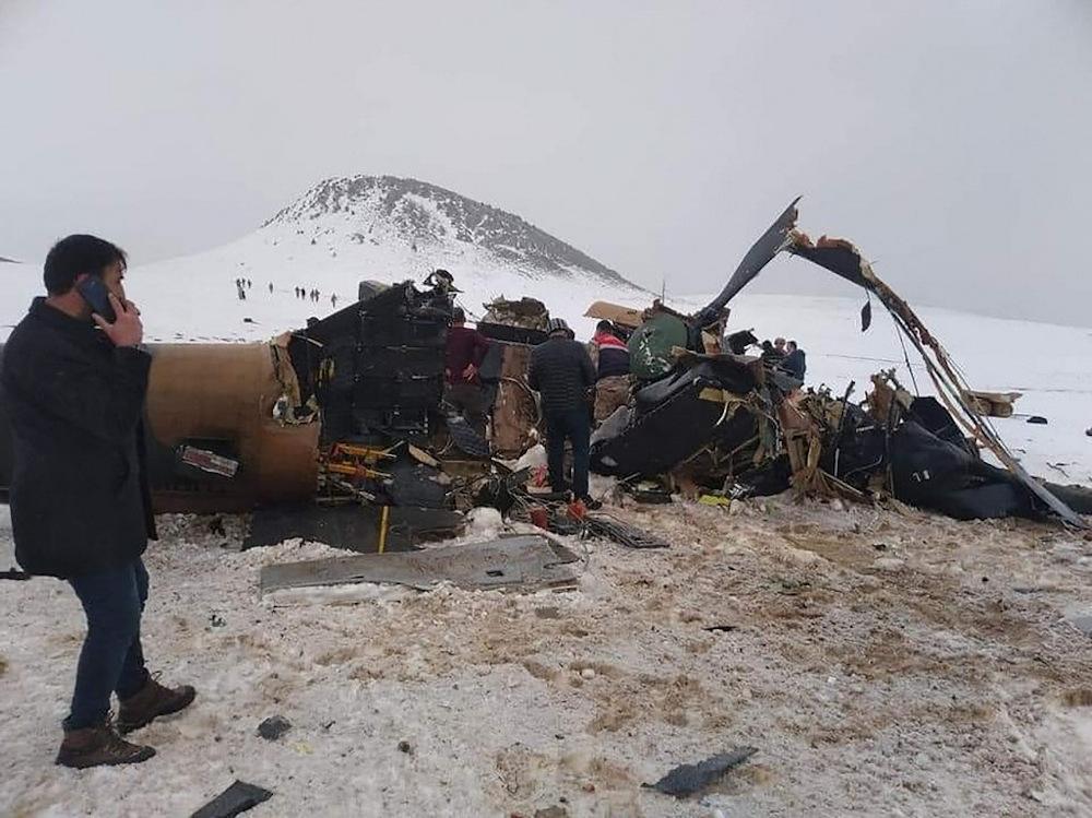 Rescue workers, soldiers and civilians walk around the wreckage of a military helicopter that crashed on March 4, 2021, near the Turkish eastern city of Bitlis. u00e2u20acu201d AFP pic
