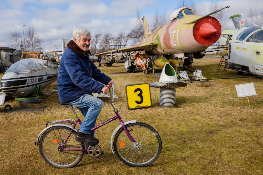 Museum owner Viktors Talpas rides a bicycle at his Aviation Museum in Riga on March 16, 2021. u00e2u20acu201d AFP pic