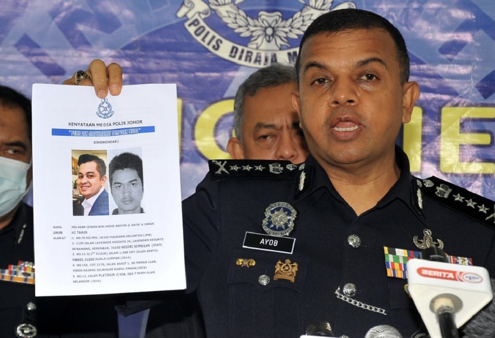 Johor police chief Datuk Ayob Khan Mydin Pitchay holding-up a photofit of the suspect that was revealed as a former deputy public prosecutor during a press conference in Johor Baru today. u00e2u20acu2022 Picture by Ben Tan