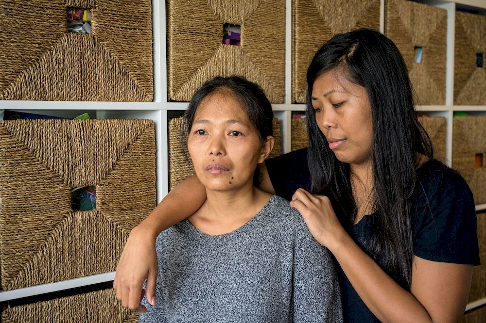In this file picture taken on March 5, 2019, Baby Jane Allas (left), a Filipina domestic worker and mother of five who was sacked after she was diagnosed with cervical cancer, poses with her younger sister Mary Ann during an interview with AFP in Hong Kon