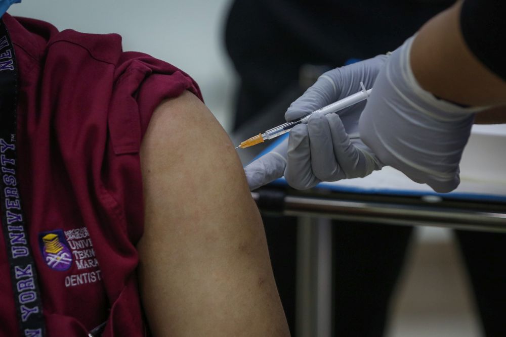 A medical worker receives his Covid-19 jab at the UiTM Hospital in Sungai Buloh March 2, 2021. u00e2u20acu201d Picture by Yusof Mat Isa