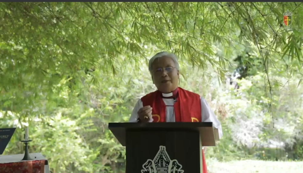 Bishop Danald carrying out the Palm Sunday service at the compound of the St Thomas Cathedral that was broadcasted live. u00e2u20acu201d Borneo Post pic