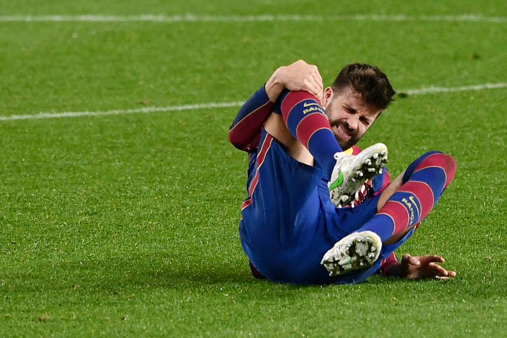 Barcelonau00e2u20acu2122s Spanish defender Gerard Pique touches his knee during Spanish Copa del Rey (Kingu00e2u20acu2122s Cup) semi-final second leg football match between FC Barcelona and Sevilla FC at the Camp Nou stadium in Barcelona March 3, 2021. u00e2u20acu201d AFP pic 