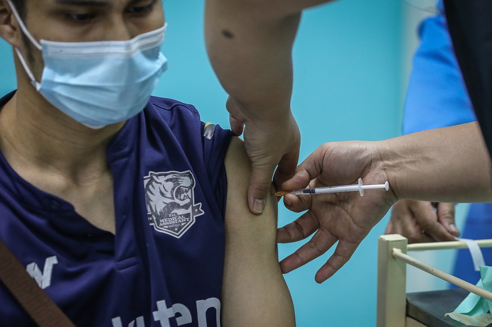 A health worker receives the Pfizer-BioNTech Covid-19 vaccine at the Klinik Kesihatan in Kelana Jaya March 6, 2021. u00e2u20acu2022 Picture by Yusof Mat Isa