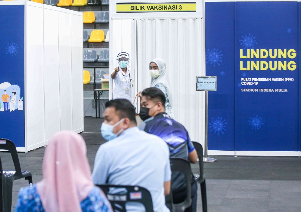 Members of the public wait to receive their Covid -19 jabs at the Indera Mulia Stadium in Ipoh March 16, 2021. u00e2u20acu201d Picture by Farhan Najib