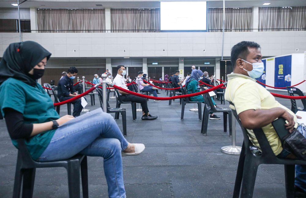 Members of the public wait to receive their Covid -19 jabs at the Indera Mulia Stadium in Ipoh March 16, 2021. u00e2u20acu201d Picture by Farhan Najib