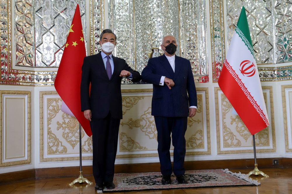 Iran's Foreign Minister Mohammad Javad Zarif and China's Foreign Minister Wang Yi bump elbows during the signing ceremony of a 25-year cooperation agreement, in Tehran March 27, 2021. u00e2u20acu201d Reuters pic