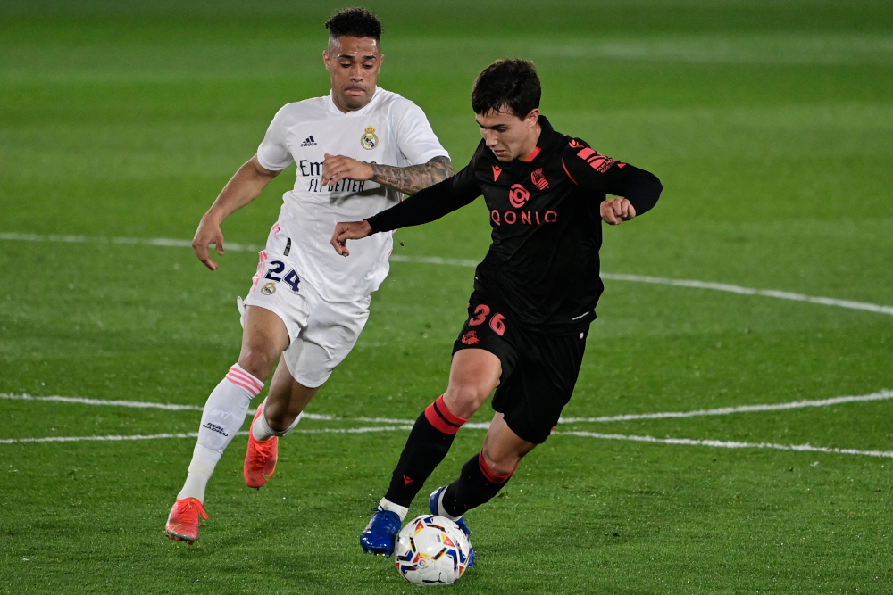 Real Madrid forward Mariano Diaz challenges Real Sociedad midfielder Martin Zubimendi during the Spanish league football match between Real Madrid CF and Real Sociedad at the Alfredo di Stefano stadium in Valdebebas, Spain, March 1, 2021. u00e2u20acu201d AFP picnn